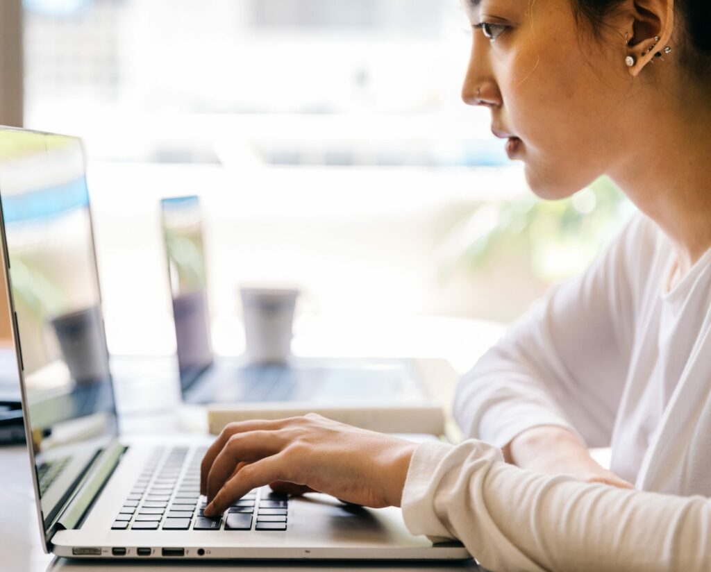 Freelance content writer typing on laptop computer